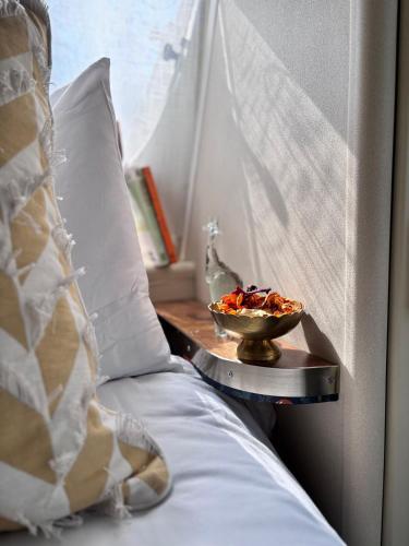 a bowl of food on a tray on a bed at Riverside Retreat in a Luxe Caravan in Sabie
