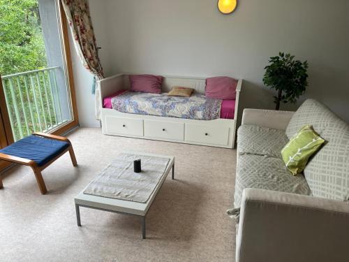 a living room with a couch and a bed at Bobby in Besançon