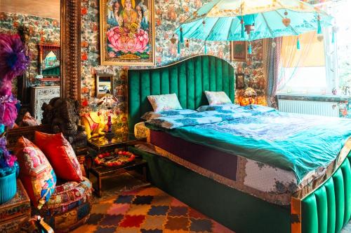 a bedroom with a bed with a green head board at Princess Palace in Gdańsk