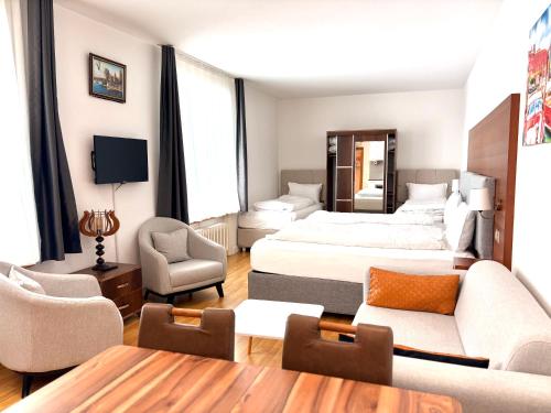 a hotel room with a bed and a living room at Akomo Bern in Bern