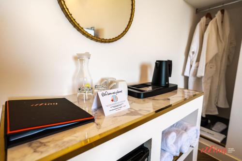 a table with a book and a mirror on it at Yolanda Boutique Suites by Zzzing in Birgu