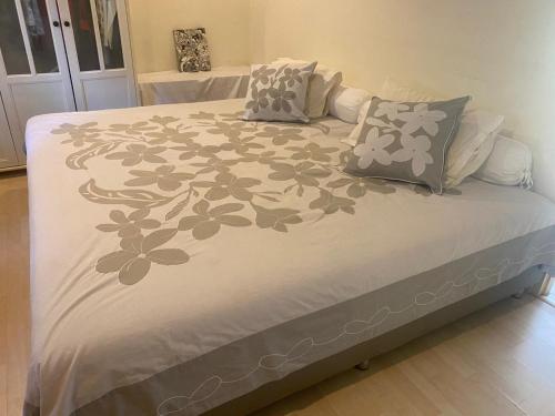 - un lit avec une couverture blanche et des fleurs dans l'établissement Chambre cosy avec jardin à Pattaya, à Jomtien Beach