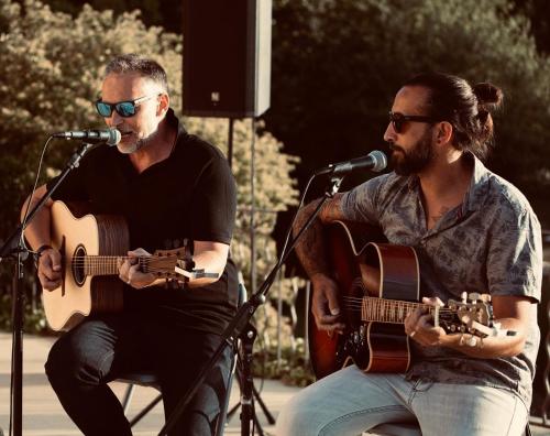 two men are playing guitar and singing sidx sidx sidx sidx sidx at Domaine Gaogaia in Aix-en-Provence