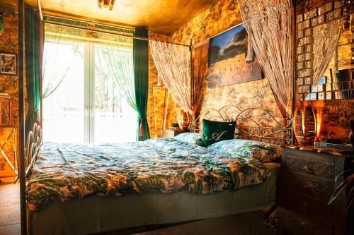 a bedroom with a bed and a window at Princess Palace in Gdańsk