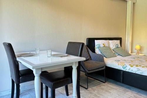 une pièce avec une table, des chaises et un lit dans l'établissement Beautiful house with garden - near park, à Gujan-Mestras