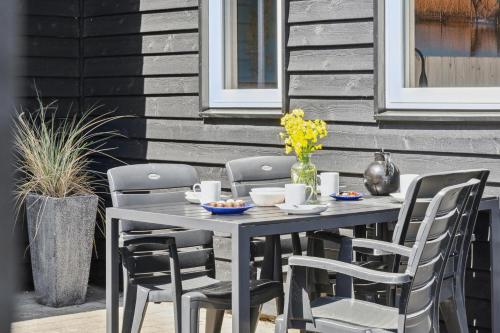 a gray table and chairs on a patio at Feriehus 1130 in Hvide Sande