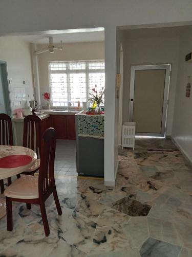 a kitchen and dining room with a marble floor at Couple place in Port Dickson