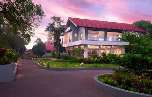 a house with a lot of lights in front of it at Gateway Coorg in Madikeri