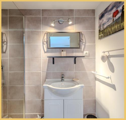 une salle de bain avec un lavabo et un miroir dans l'établissement Chez Bert I Studio I Perrignier, à Perrignier