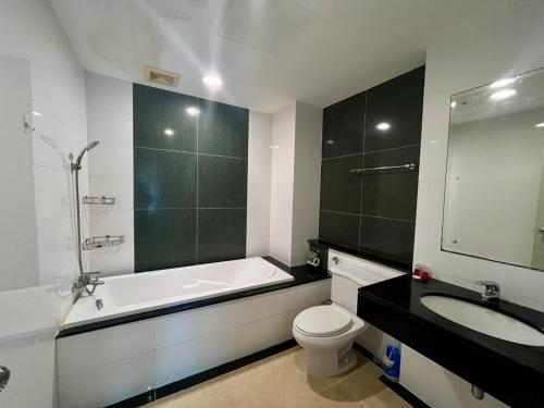 a bathroom with a tub and a toilet and a sink at Luxury Villa Patong in Patong Beach