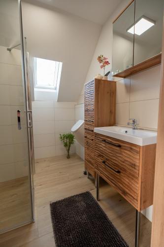 a bathroom with a sink and a mirror and a shower at Apartment - Wolfsberg in Sankt Johann
