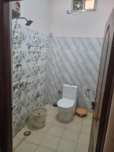 a bathroom with a toilet and a shower at Hotel Sandeep palace in Jāmb