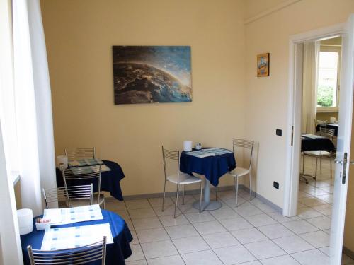a dining room with a blue table and chairs at Hotel Motel Fiore in Fiorenzuola dʼArda