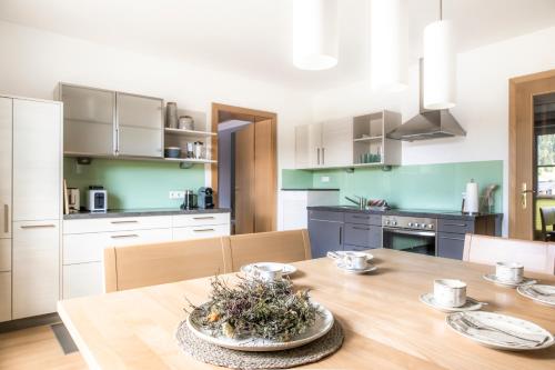 a kitchen with a wooden table and a dining room at Höllhof Dachstein West in Russbach am Pass Gschütt
