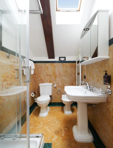 a bathroom with two toilets and a sink and a shower at Charles Bridge Palace in Prague