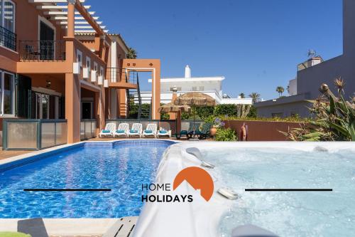 a villa with a swimming pool and a house at #307 Vila Branca by Home Holidays in Albufeira