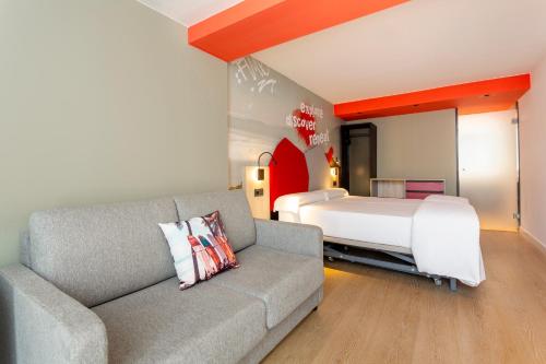 a living room with a couch and a bed at Sholeo Lodges Maspalomas in Playa del Ingles