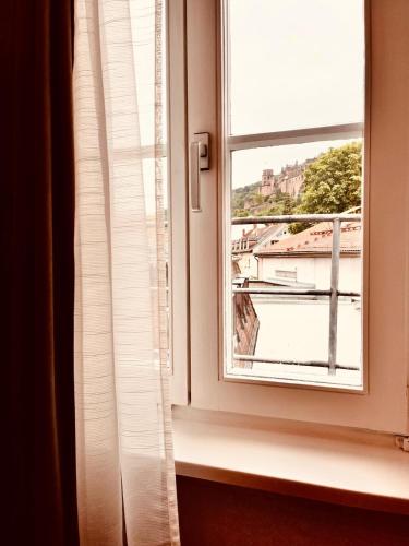 a window with a view of a city at Hotel Zum Pfalzgrafen in Heidelberg