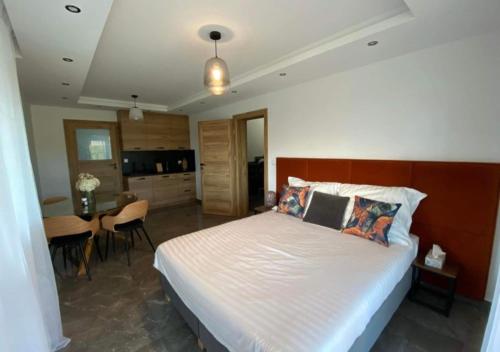 a bedroom with a large bed and a dining room at Agro Komfort in Bakałarzewo