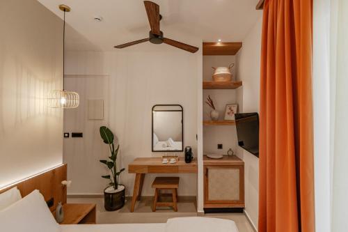 a room with a table with a mirror and a desk at Sarana Suites Crete in Kissamos