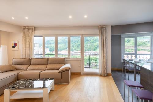 a living room with a couch and a table at Zerkausi - baskeyrentals in Tolosa