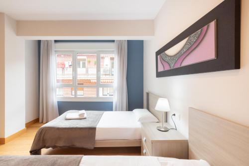 a hotel room with two beds and a window at Zerkausi - baskeyrentals in Tolosa
