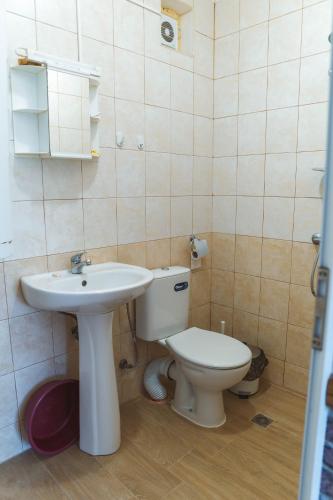 a bathroom with a sink and a toilet at Guest House Nevena in Shabla