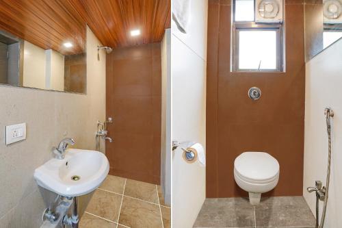 a bathroom with a toilet and a sink at FabHotel Gargi Deluxe in Pune