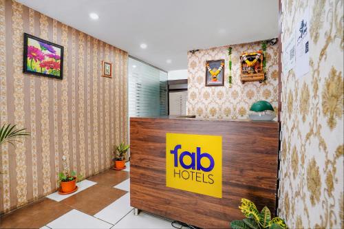 a ibo hotel lobby with a sign on the wall at FabHotel Gargi Deluxe in Pune