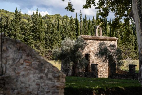 an old stone building in a field with trees at Château de Taulignan in Saint-Marcellin-lès-Vaison