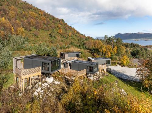 a group of modular homes on a hill with the water at Torvika Seaview Pods in Bølandet