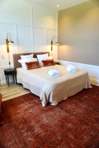 a bedroom with a large bed with two towels on it at Château de Taulignan in Saint-Marcellin-lès-Vaison