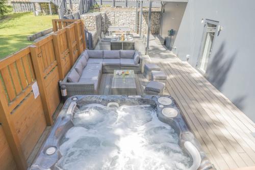 a hot tub on the deck of a house at The Neuk in Kincraig