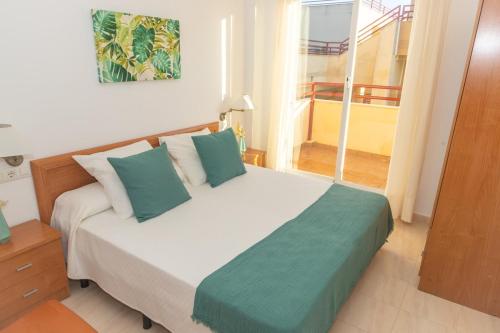 a bedroom with a large bed with a large window at Apartamento Sereno 4 | Piscina, Garaje, Terraza y Playa in Los Caños de Meca