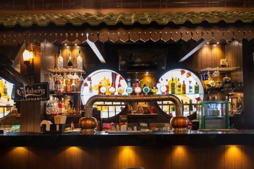 a bar in a restaurant with a lot of alcohol at Hotel Peninsula Redpine in Mumbai