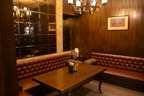 a dining room with a table and leather seats at Hotel Peninsula Redpine in Mumbai