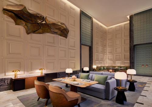 a living room with a couch and a table at Four Seasons Hotel Mumbai in Mumbai