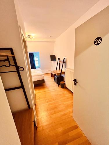 a room with a bedroom with a bed and a ladder at Hotel Zum Pfalzgrafen in Heidelberg