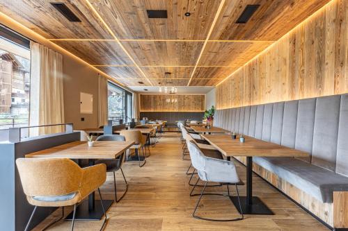 a row of tables and chairs in a restaurant at Paradise Lodge in Livigno