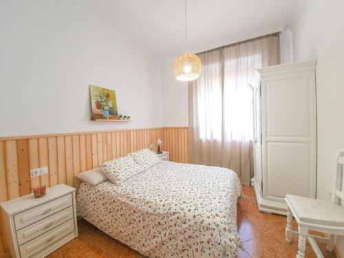 a bedroom with a bed and a dresser and a window at Casa Maria Luisa | +Patio in Barbate