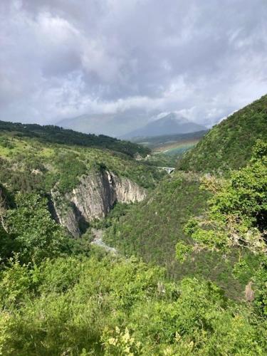 a view of a mountain with a road on it at L'ecrin de bois in Ponsonnas