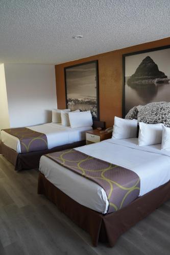 a hotel room with two beds in a room at Super 8 by Wyndham Fernley in Fernley
