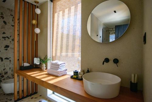 a bathroom with a large white tub and a mirror at Villa Eleven in Dubrovnik