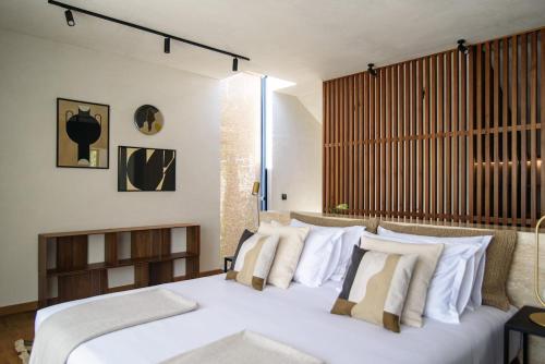 a bedroom with a large white bed with white pillows at Villa Eleven in Dubrovnik