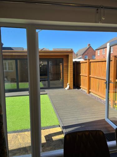 a view of a deck from the window of a house at Cosy Hideout in Timperley