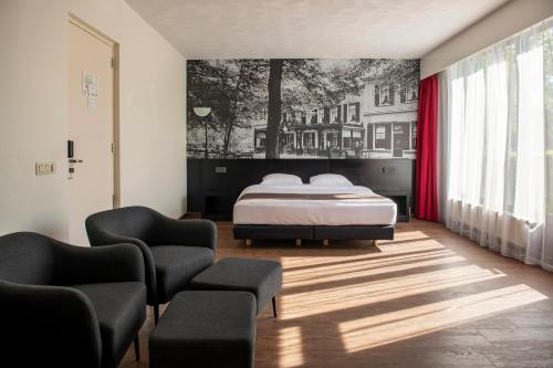 Ένα ή περισσότερα κρεβάτια σε δωμάτιο στο Bastion Hotel Apeldoorn Het Loo