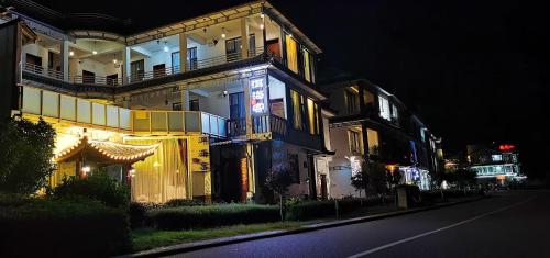 a building with lights on the side of a street at Erhaike Seaview Inn in Dali