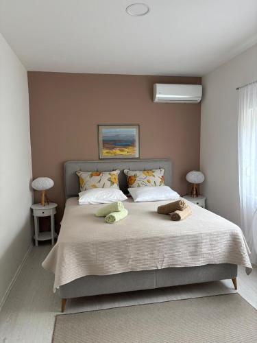 a bedroom with a bed with two towels on it at Villa Vita in Mostar