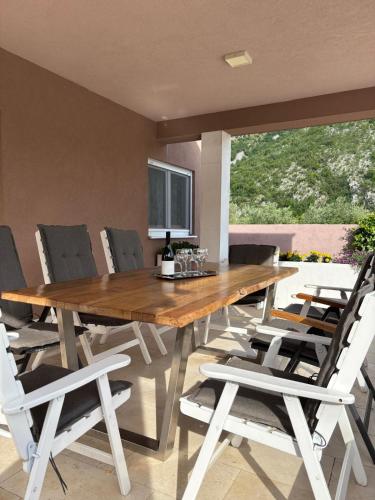 a dining room with a wooden table and chairs at Villa Vita in Mostar