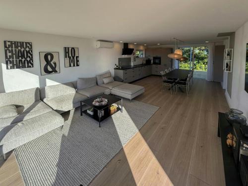 a living room with a couch and a table at Renovated Holiday Home With Sea View In Skåstrup in Bogense